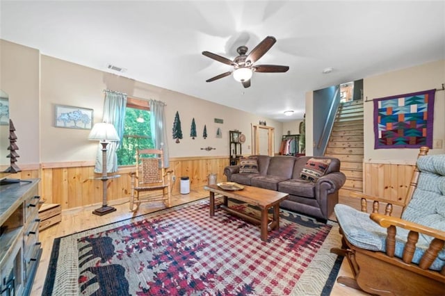 100 Julep Cir, Ellijay, GA 30540 - living area with wainscoting, wooden walls, stairway, wood finished floors, and ceiling fan