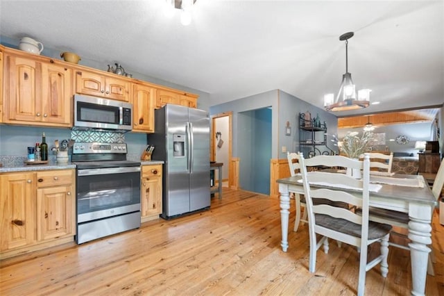 100 Julep Cir, Ellijay, GA 30540 - kitchen featuring stainless steel appliances, light wood-style flooring, light countertops, pendant lighting, and a chandelier