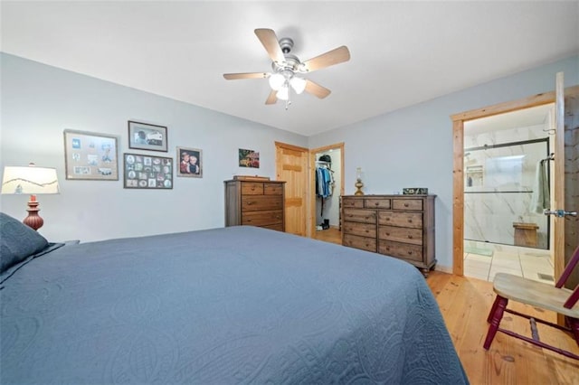 100 Julep Cir, Ellijay, GA 30540 - bedroom with light wood-style flooring, a spacious closet, connected bathroom, a ceiling fan, and a closet