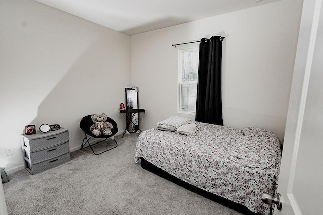 carpeted bedroom featuring baseboards