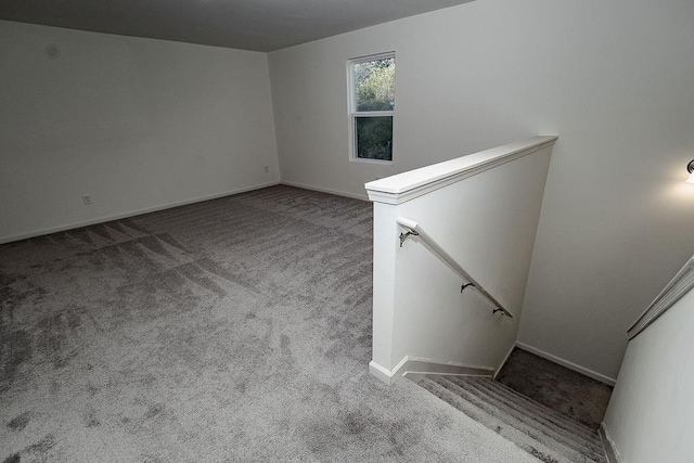 carpeted empty room with baseboards