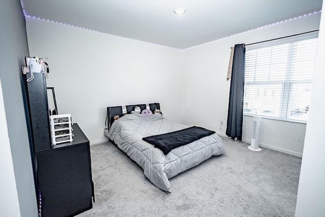 carpeted bedroom with baseboards