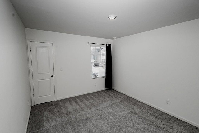 empty room with carpet and baseboards