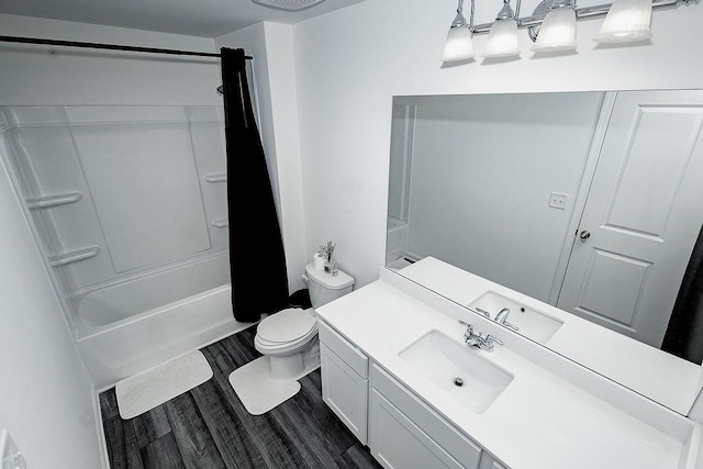 full bath featuring shower / bath combination, vanity, toilet, and wood finished floors