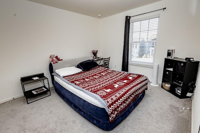 carpeted bedroom featuring baseboards