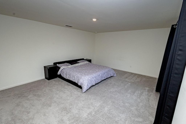 carpeted bedroom with visible vents and baseboards