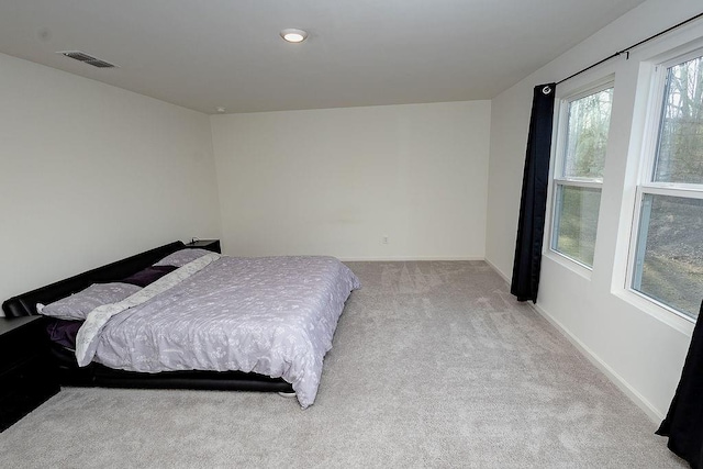 carpeted bedroom featuring baseboards and visible vents