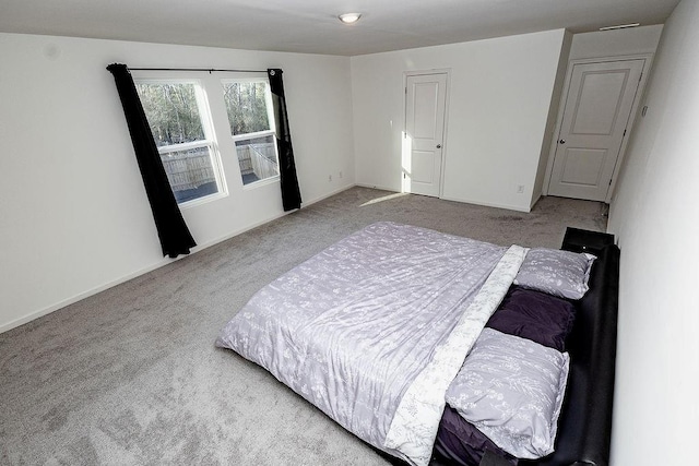 bedroom featuring carpet floors and baseboards