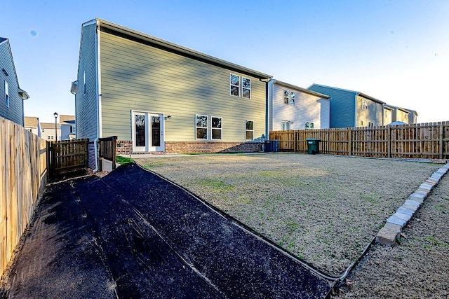 back of property featuring a fenced backyard and brick siding