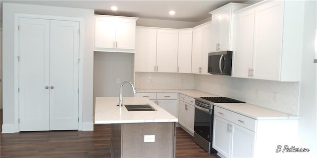 1071 Crest Mill Dr, Marietta, GA 30008 - kitchen with stainless steel range with gas cooktop, dark wood-style flooring, white cabinets, and recessed lighting