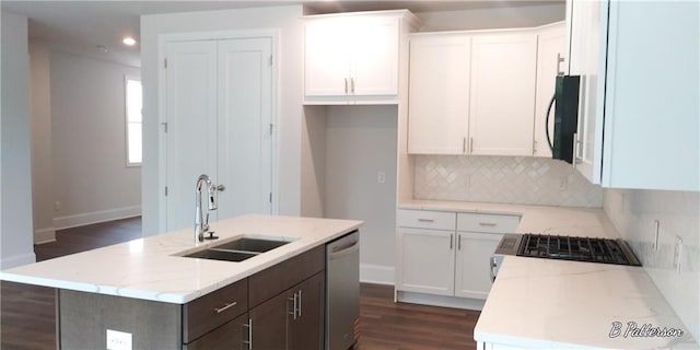 1071 Crest Mill Dr, Marietta, GA 30008 - kitchen featuring dishwasher, decorative backsplash, black microwave, white cabinetry, and a center island with sink