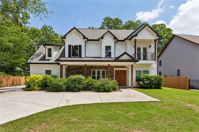 2721 Old Concord Rd SE, Smyrna, GA 30082 - view of front of house featuring a standing seam roof, french doors, a balcony, covered porch, and metal roof