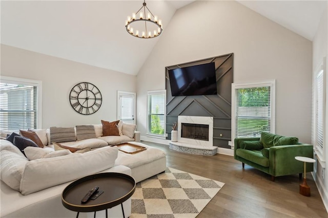 2721 Old Concord Rd SE, Smyrna, GA 30082 - living room with high vaulted ceiling, a chandelier, healthy amount of natural light, and wood finished floors