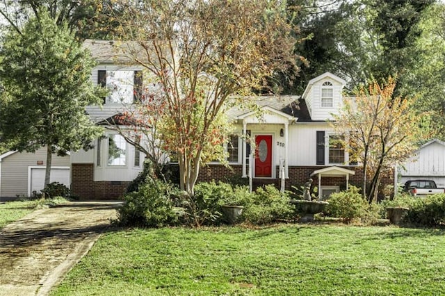 view of front of house featuring a garage and a front lawn