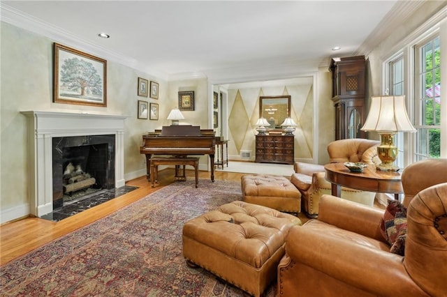 living area featuring visible vents, wood finished floors, a premium fireplace, and ornamental molding