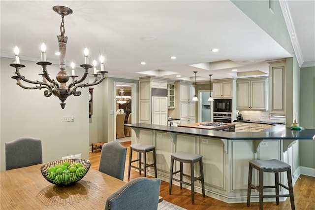 kitchen with crown molding, dark countertops, black microwave, and oven