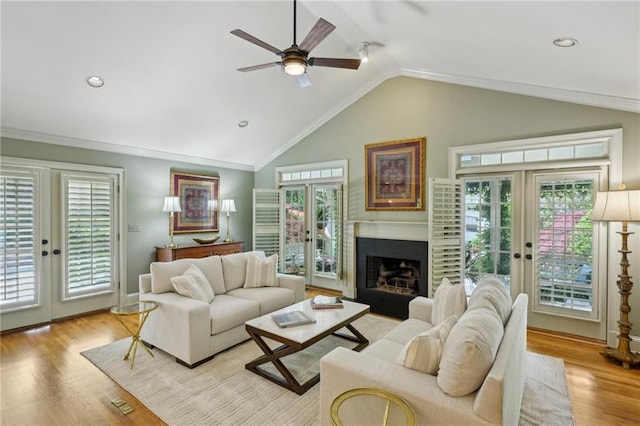 living area with french doors, a healthy amount of sunlight, and a ceiling fan