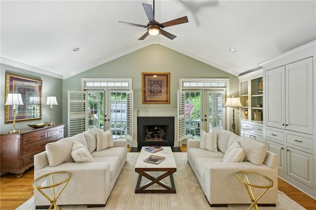 living room featuring ceiling fan, light wood-style flooring, and plenty of natural light