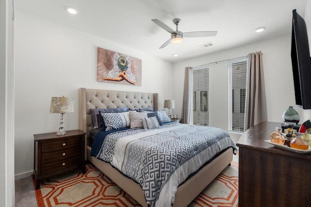 bedroom featuring light carpet and ceiling fan