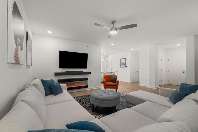 living room with ceiling fan and light wood-type flooring