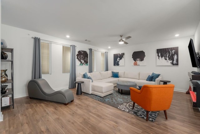 living room featuring hardwood / wood-style flooring and ceiling fan