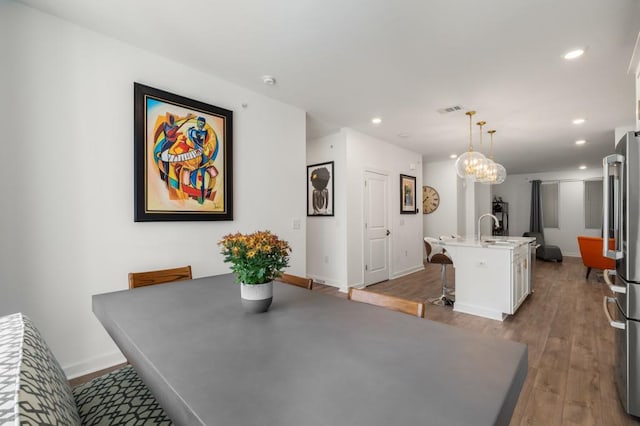 dining room with wood-type flooring and sink