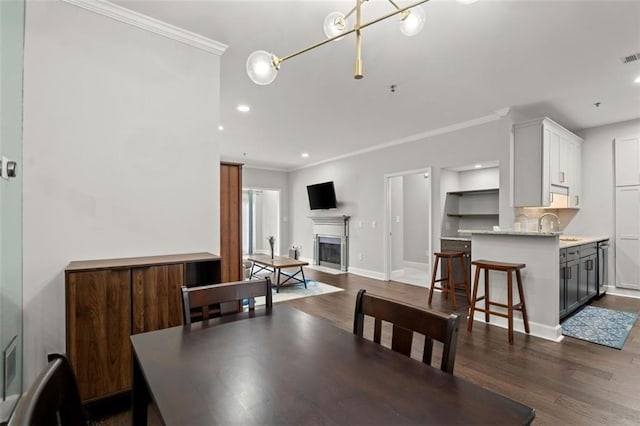 2865 Lenox Rd NE Unit 410, Atlanta, GA 30324 - dining area with dark wood-type flooring, ornamental molding, recessed lighting, and a fireplace