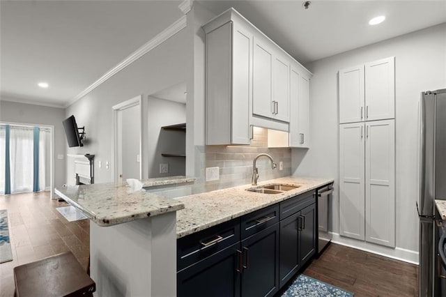2865 Lenox Rd NE Unit 410, Atlanta, GA 30324 - kitchen featuring light stone countertops, appliances with stainless steel finishes, a sink, dark wood finished floors, and white cabinetry