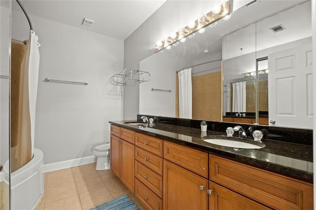 2865 Lenox Rd NE Unit 410, Atlanta, GA 30324 - full bathroom featuring double vanity, visible vents, tile patterned flooring, a sink, and toilet