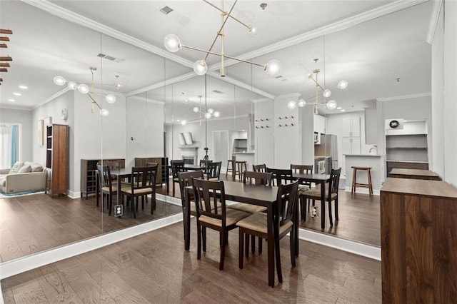 2865 Lenox Rd NE Unit 410, Atlanta, GA 30324 - dining area featuring an inviting chandelier, baseboards, ornamental molding, and dark wood finished floors