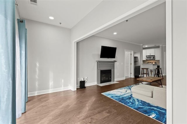 2865 Lenox Rd NE Unit 410, Atlanta, GA 30324 - unfurnished living room with visible vents, a fireplace with flush hearth, wood finished floors, baseboards, and recessed lighting