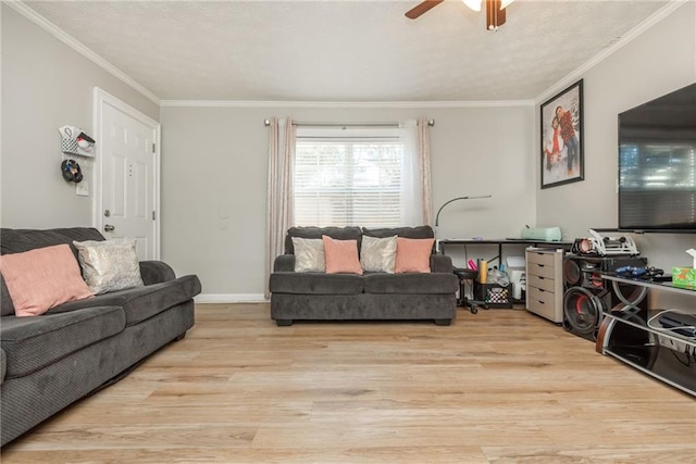 living room featuring ceiling fan, ornamental molding, and light hardwood / wood-style floors