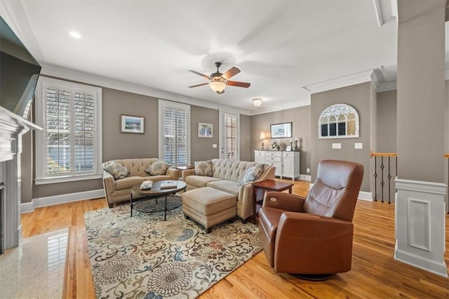 living area with light wood-type flooring, plenty of natural light, and baseboards