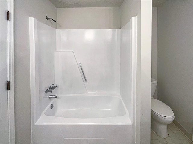 bathroom with tile patterned flooring, shower / washtub combination, and toilet