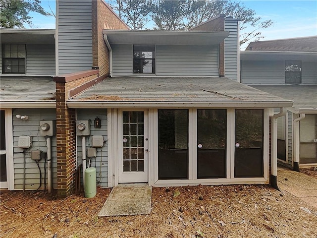 rear view of property with a sunroom