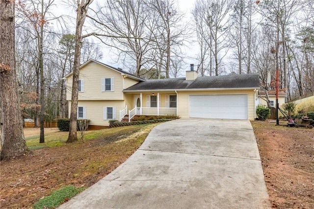 split level home featuring covered porch and a garage