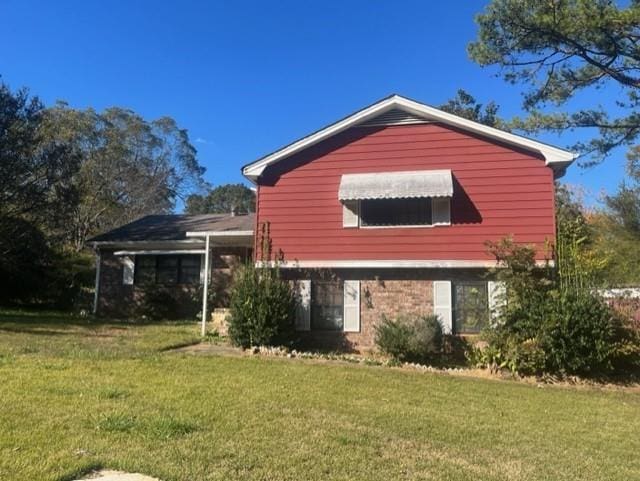 rear view of property featuring a yard