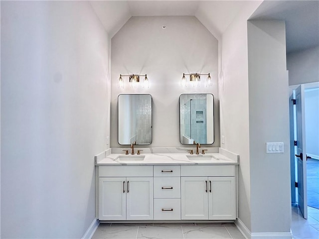 bathroom with vanity and vaulted ceiling