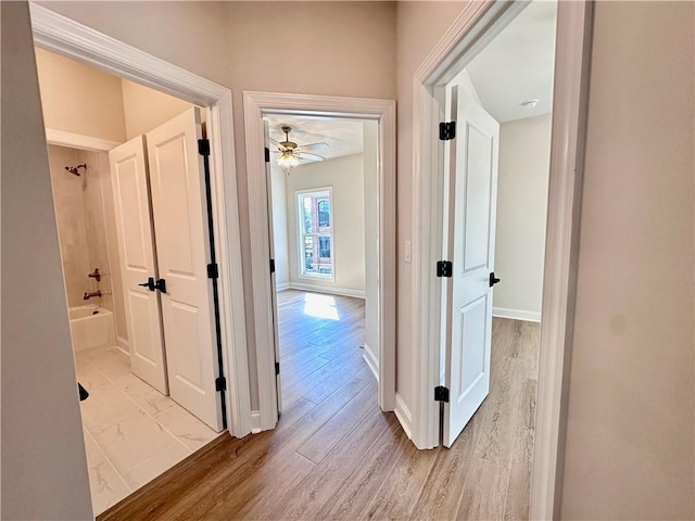 corridor featuring light hardwood / wood-style floors