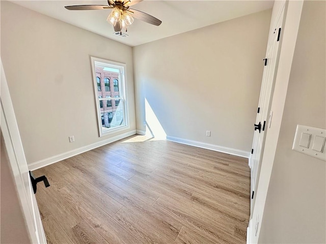 empty room featuring light wood-type flooring and ceiling fan