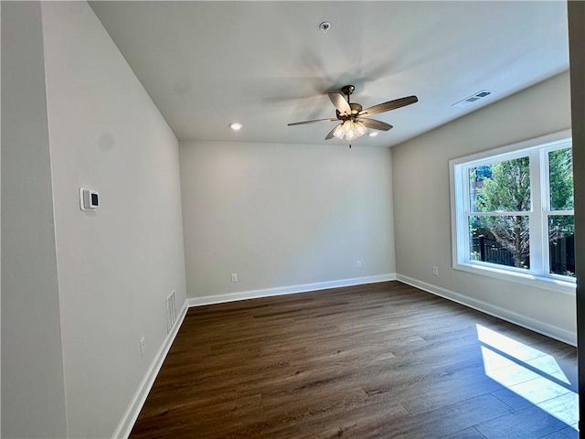 unfurnished room featuring ceiling fan and dark wood-type flooring