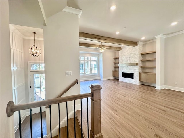 unfurnished living room featuring beamed ceiling, hardwood / wood-style flooring, and a healthy amount of sunlight