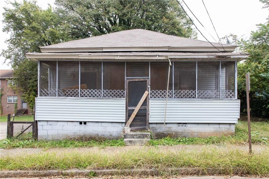 108 Vine St SW, Atlanta, GA 30314 - view of front of home featuring roof with shingles, a sunroom, and crawl space
