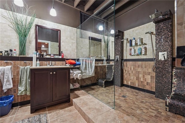 2030 Spring End Ct, Lawrenceville, GA 30044 - bathroom featuring tile walls, walk in shower, vanity, and wainscoting