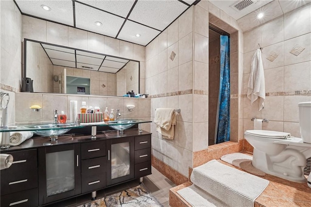 2030 Spring End Ct, Lawrenceville, GA 30044 - full bathroom with tile walls, toilet, a tile shower, double vanity, and tile patterned floors