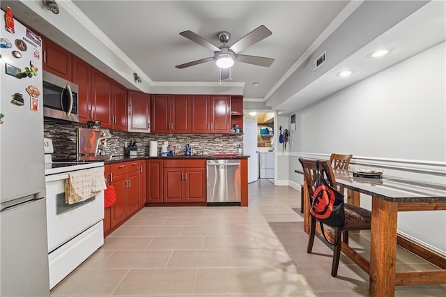 2030 Spring End Ct, Lawrenceville, GA 30044 - kitchen featuring appliances with stainless steel finishes, dark brown cabinets, backsplash, independent washer and dryer, and a ceiling fan