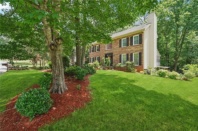 2030 Spring End Ct, Lawrenceville, GA 30044 - colonial-style house featuring a chimney, a front lawn, and brick siding