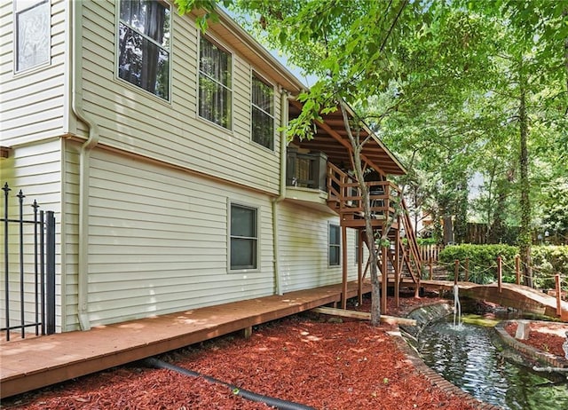 2030 Spring End Ct, Lawrenceville, GA 30044 - view of side of property featuring a garden pond and a deck