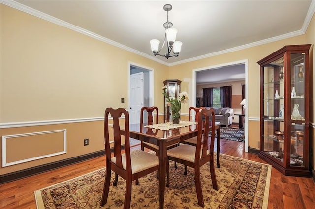 2030 Spring End Ct, Lawrenceville, GA 30044 - dining room featuring a chandelier, crown molding, wood finished floors, and baseboards