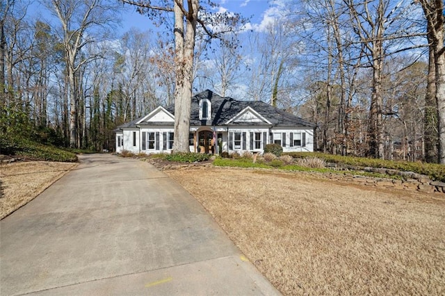 cape cod home featuring driveway